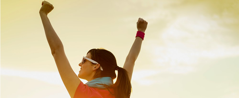 woman raises her hands in triumph